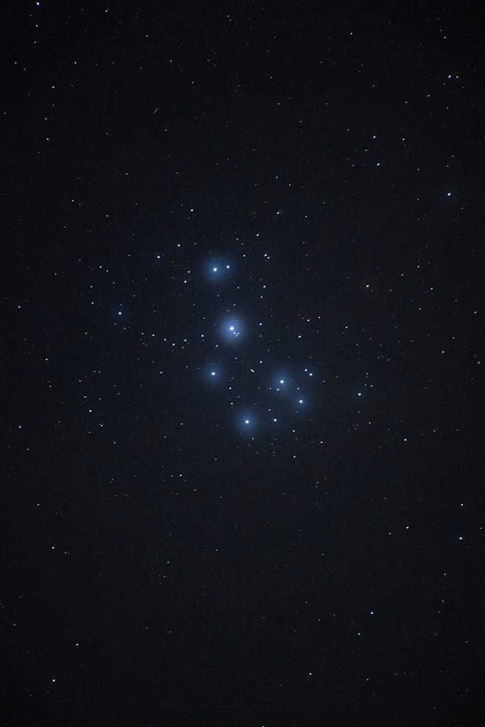 Captivating image of the Pleiades star cluster glowing in the night sky.