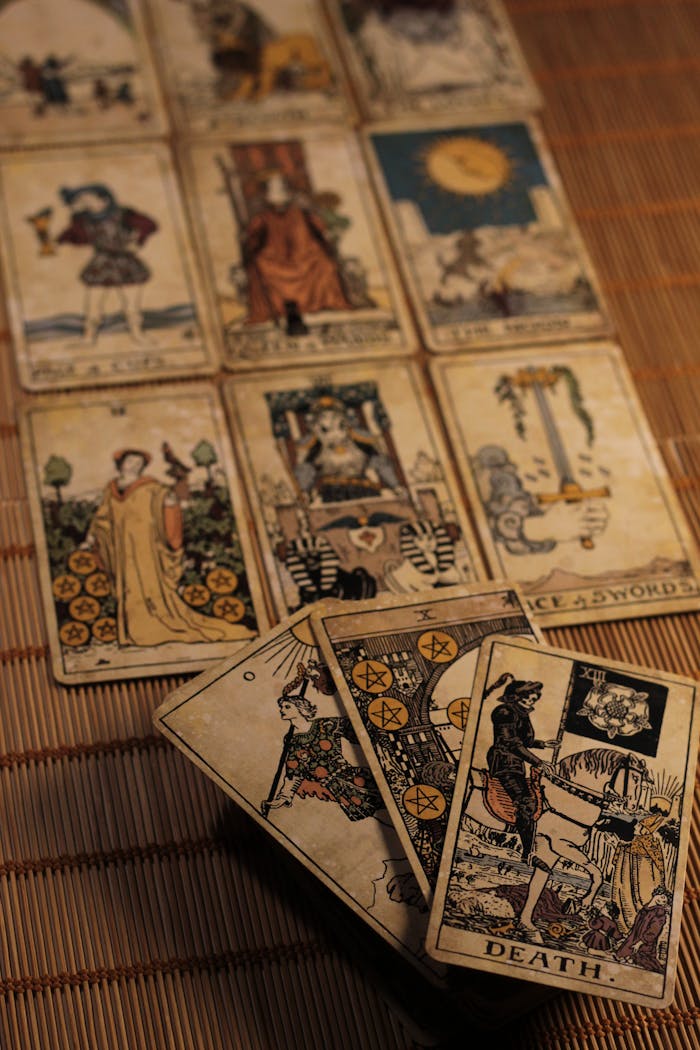 A captivating spread of vintage tarot cards laid out on a bamboo mat, creating a mystical ambiance.